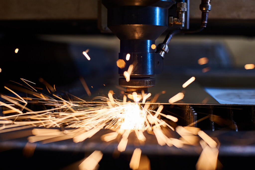 CNC Laser cutting of metal close up, modern industrial technology. Small depth of field.