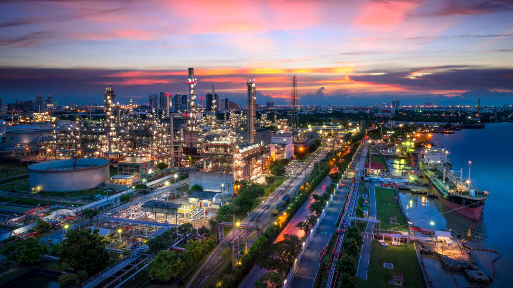 an oil and gas plant at sunset