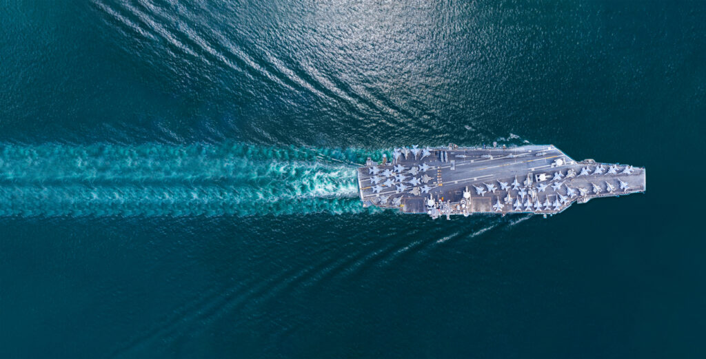 naval aricraft carrier in the sea which requires marine components